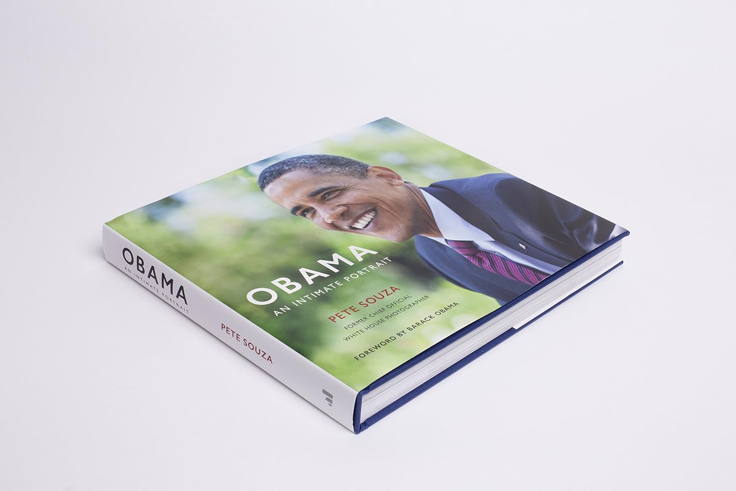 Inside page of Obama: An Intimate Portrait by Pete Souza showing White House photography