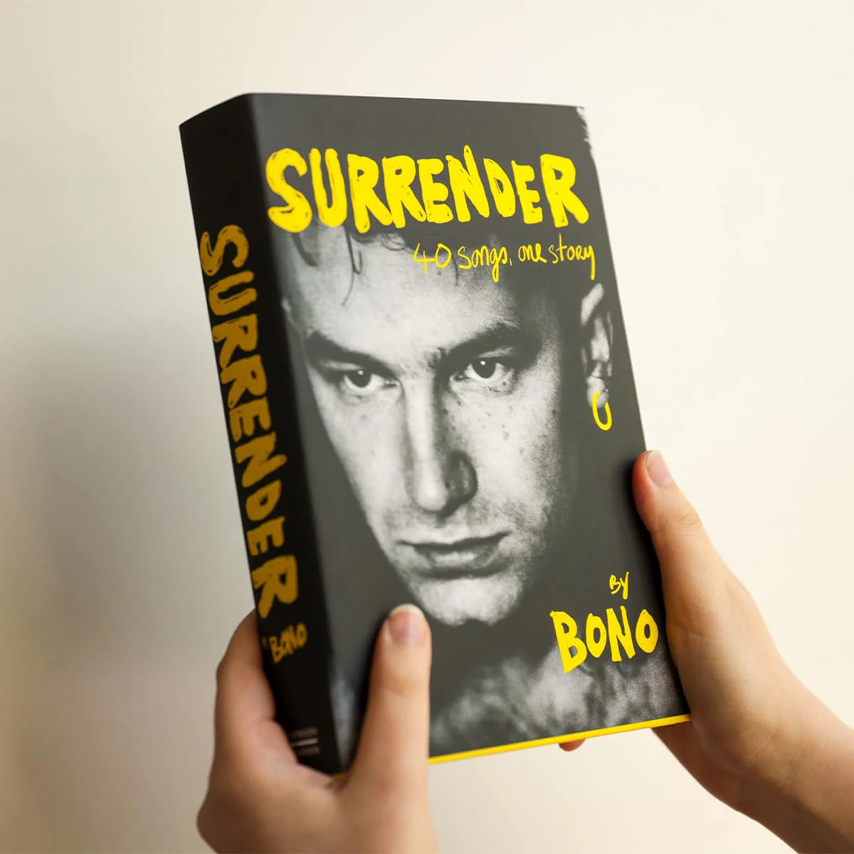 Surrender: 40 Songs, One Story by Bono - hardback book angled view showing pages